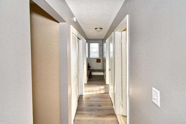 hall with light hardwood / wood-style flooring