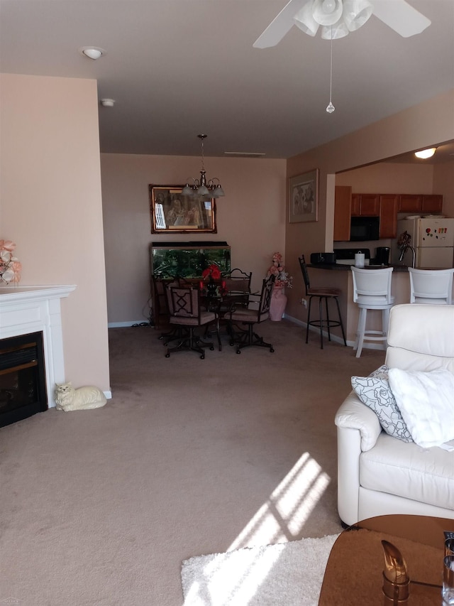 carpeted living room with ceiling fan