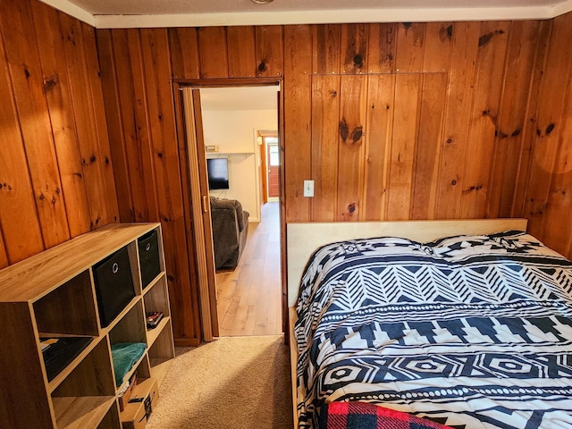 bedroom with wood finished floors and wooden walls