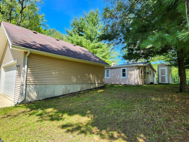 exterior space featuring a lawn and a garage