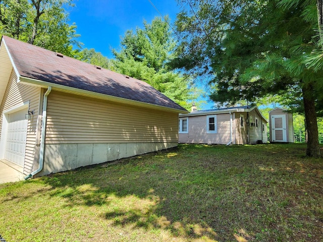view of home's exterior featuring a lawn, an outdoor structure, and a shed