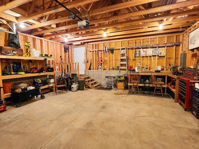 garage with a workshop area and a garage door opener