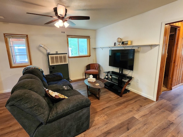 living room with baseboards, a ceiling fan, and wood finished floors