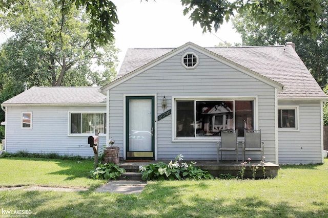 bungalow-style house with a front yard