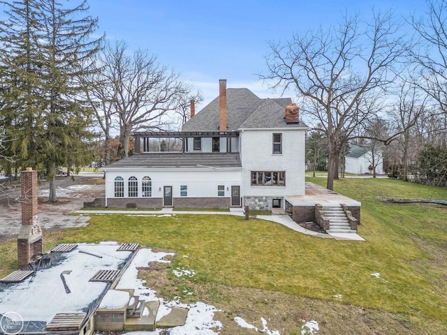 rear view of house featuring a patio area and a lawn