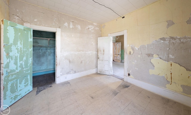 unfurnished bedroom with tile patterned floors and a closet