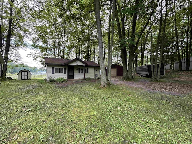 view of front of property with a front lawn and a storage unit