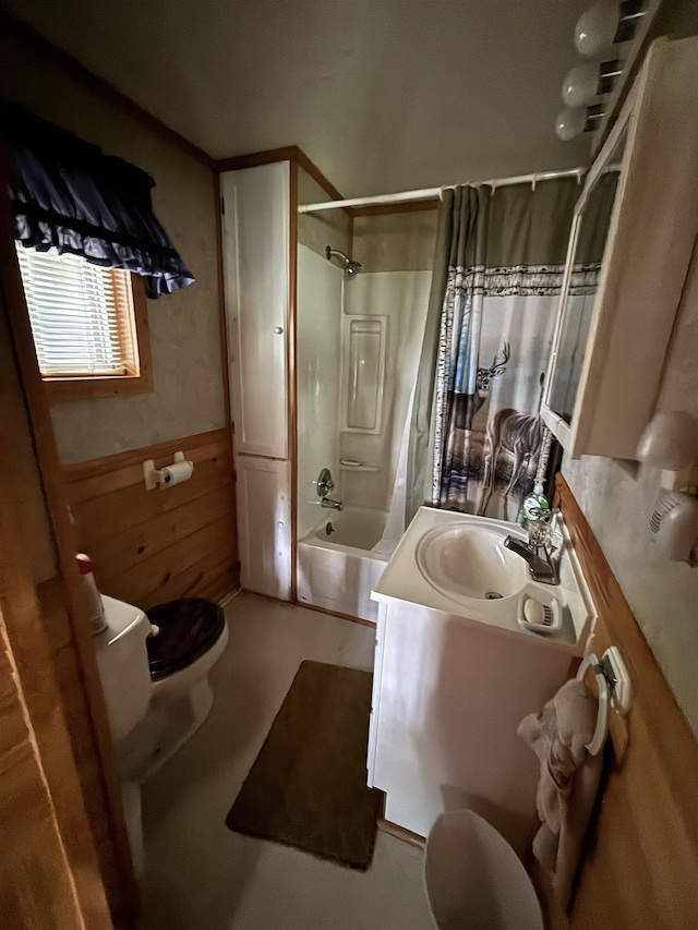 full bathroom with wooden walls, vanity, toilet, and shower / bathing tub combination