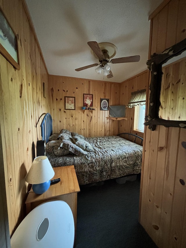 carpeted bedroom with wooden walls and ceiling fan