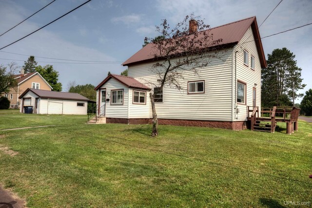 back of property featuring a lawn