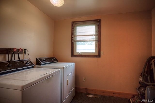 clothes washing area with carpet flooring and washer and dryer