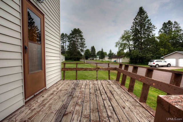 deck featuring a garage and a yard