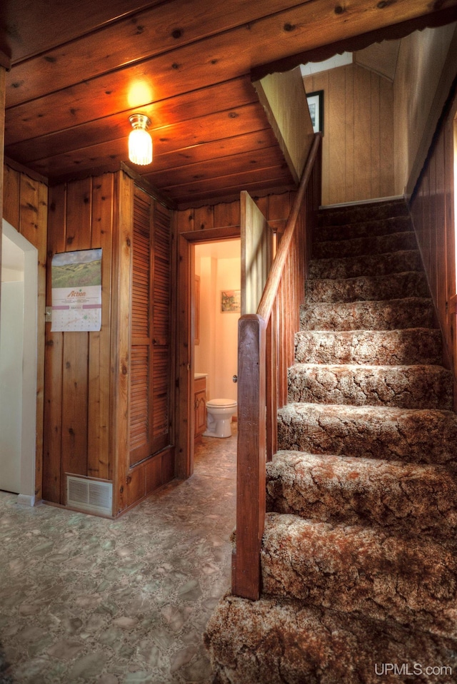 staircase with wooden walls