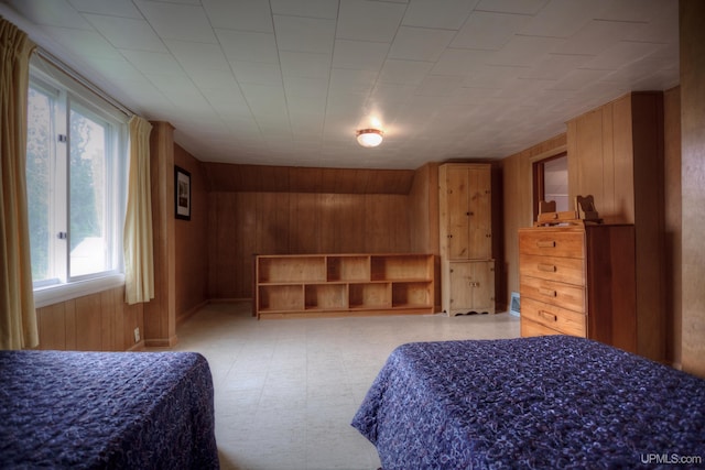 bedroom with wood walls