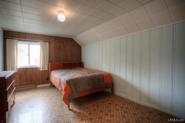 bedroom featuring wood walls and vaulted ceiling