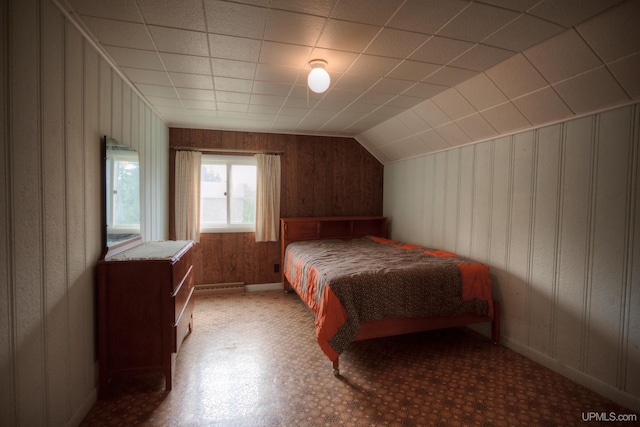 bedroom with wood walls and vaulted ceiling