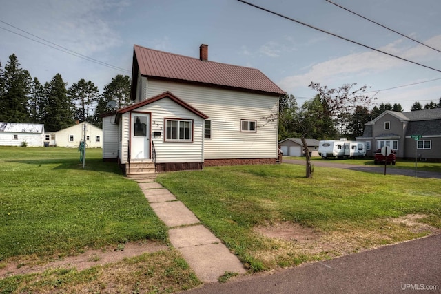 view of front of house featuring a garage and a front yard