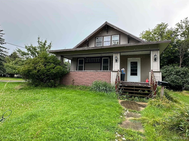 bungalow-style home featuring a porch and a front yard