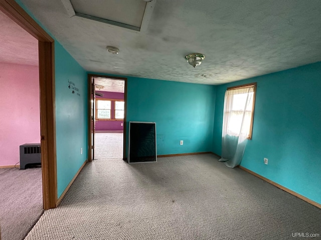 unfurnished living room with carpet and a textured ceiling