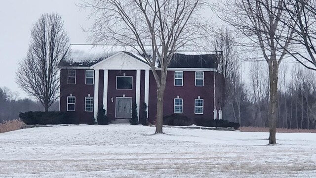 greek revival house with a front yard