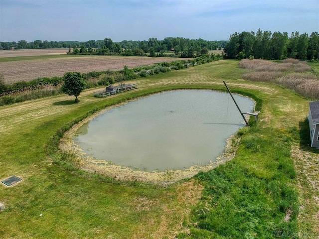 view of community with a water view, a lawn, and a rural view