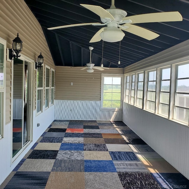 unfurnished sunroom featuring lofted ceiling and ceiling fan