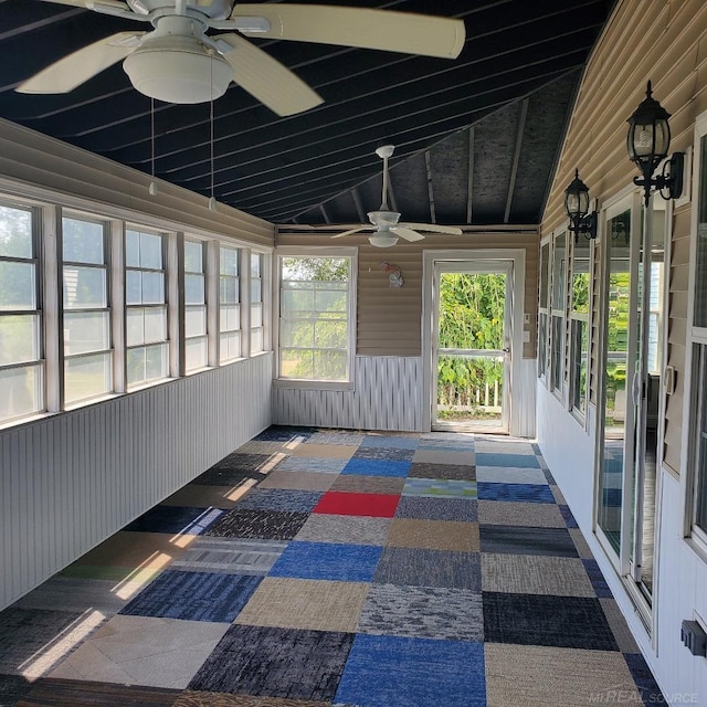 unfurnished sunroom featuring ceiling fan and vaulted ceiling