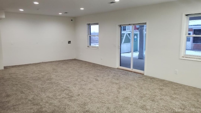 carpeted empty room featuring recessed lighting