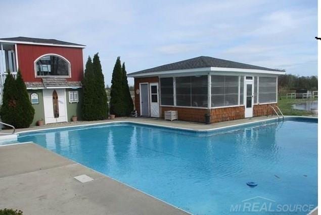 pool featuring an outbuilding and an exterior structure