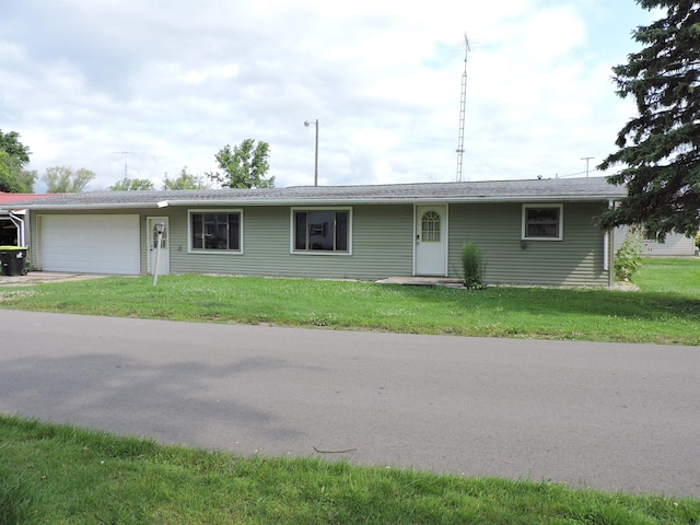 single story home featuring a garage and a front yard