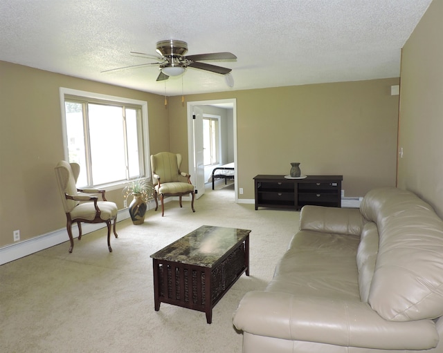 living room featuring a textured ceiling, light colored carpet, and ceiling fan