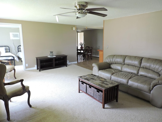 carpeted living room with a textured ceiling and ceiling fan