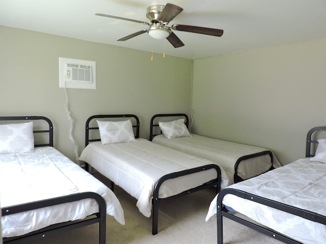 carpeted bedroom featuring a wall mounted AC and ceiling fan