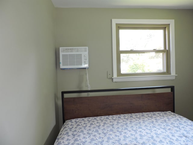 unfurnished bedroom with a wall mounted AC and carpet floors