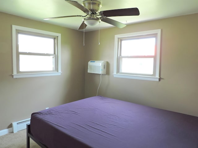 carpeted bedroom with baseboard heating, a wall unit AC, and ceiling fan