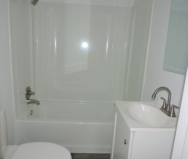 full bathroom featuring toilet, vanity, and tub / shower combination