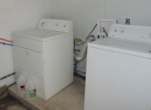 clothes washing area with washing machine and dryer