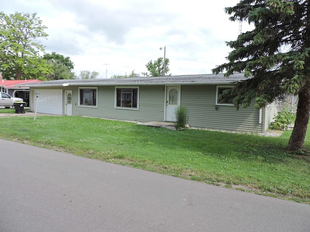 single story home with a garage and a front yard