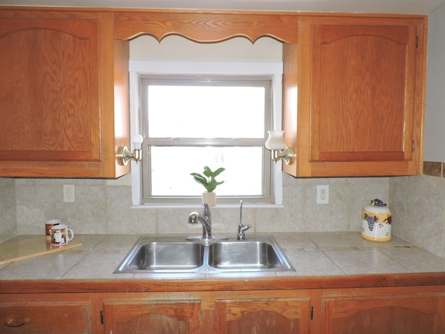 kitchen with sink, a healthy amount of sunlight, and tile counters