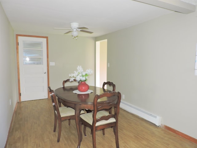 dining space featuring a baseboard heating unit, light hardwood / wood-style floors, and ceiling fan