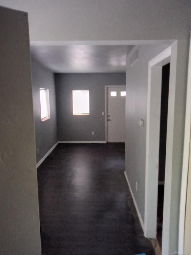 spare room featuring dark wood-type flooring