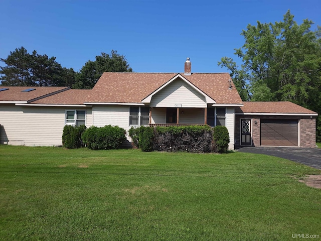 single story home featuring a garage and a front lawn