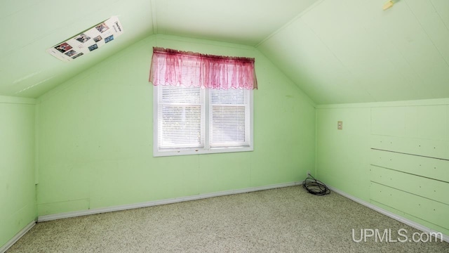 additional living space with vaulted ceiling and carpet floors