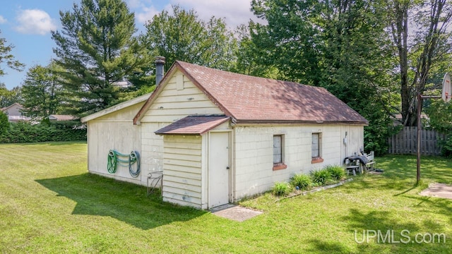 view of outbuilding with a yard