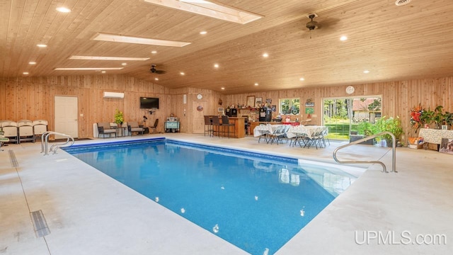 view of pool with a skylight and ceiling fan