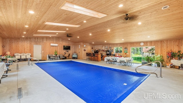 view of pool with ceiling fan and a skylight