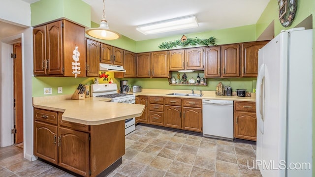 kitchen with sink, hanging light fixtures, white appliances, and light tile patterned floors