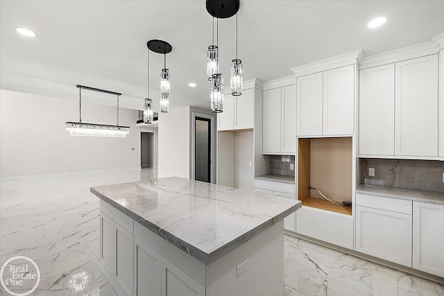 kitchen featuring light stone counters, marble finish floor, recessed lighting, white cabinetry, and a kitchen island