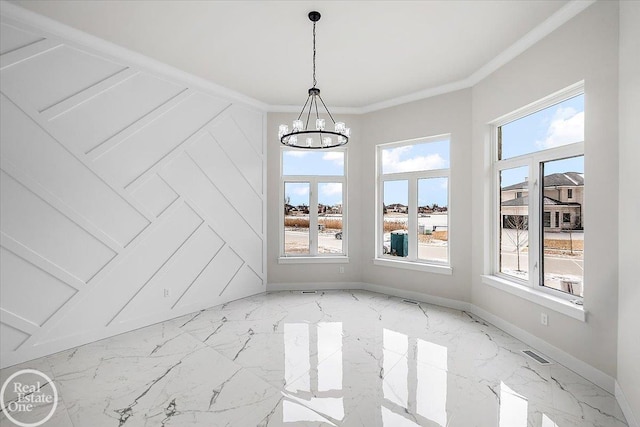 unfurnished dining area featuring ornamental molding and a chandelier