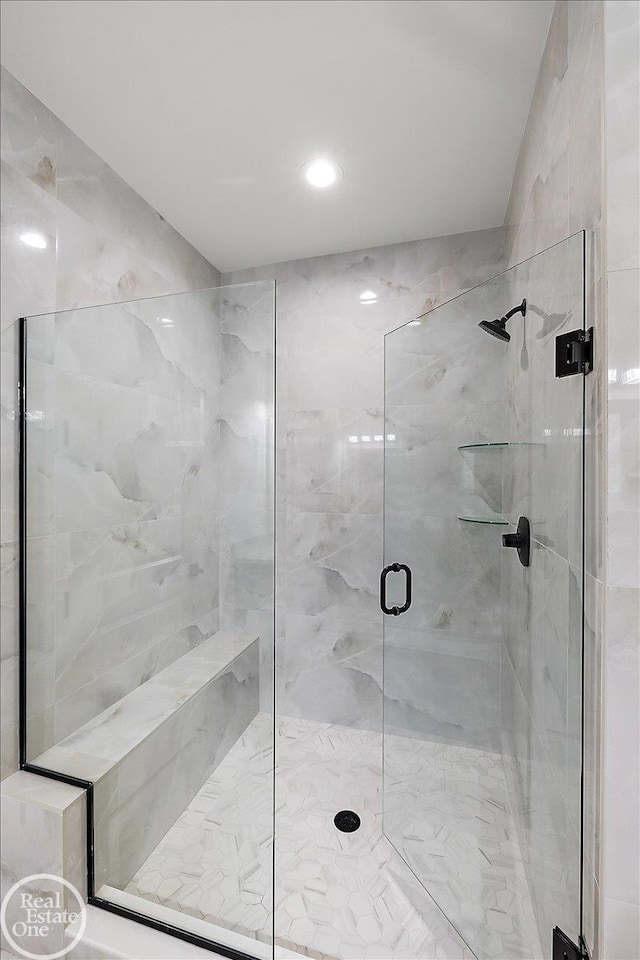 bathroom featuring a shower with shower door